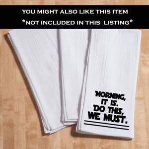 May include: Set of four white kitchen towels with black text. The text reads "Morning, It Is. Do This, We Must."