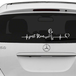 May include: White vinyl decal with a running figure, a heartbeat, and the text "just Run" on a black car window.