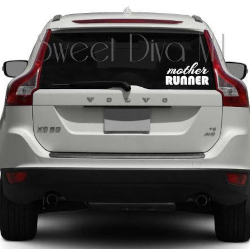May include: White car with a black rear window and a white vinyl decal that says "mother runner" on the back.