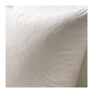May include: A white pillowcase with a smooth, textured surface.