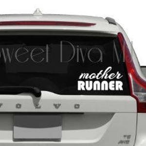 May include: White vinyl decal with the text "mother runner" in a cursive font. The decal is applied to the back window of a white SUV.