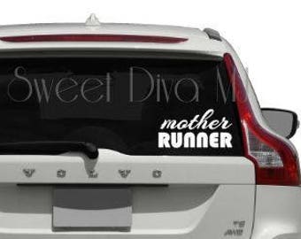 May include: White vinyl decal with the text "mother runner" in a cursive font. The decal is applied to the back window of a white SUV.