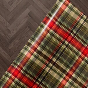 a close-up view of a plaid fabric with a wooden floor in the background.