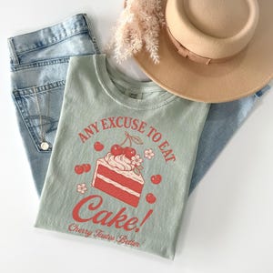 a pair of jeans and a t - shirt with a cake on it