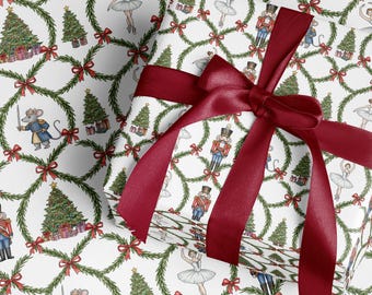 May include: Christmas-themed wrapping paper with a white background featuring a repeating pattern of green wreaths, red bows, Christmas trees, ballerinas, nutcrackers, and a mouse soldier. A wrapped gift is tied with a burgundy ribbon.