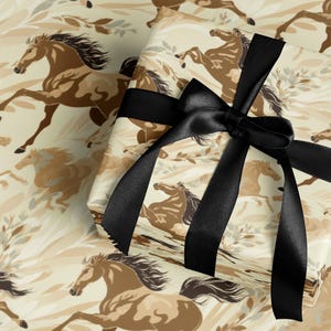 a gift box with a black ribbon tied around it, decorated with a pattern of brown horses.