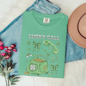 Lucky Call T-Shirt, Green St Patrick's Day Tee, Irish Lucky Charm Shirt, Clover Coin Bag Design, Fun Graphic Tee, Holiday Wear