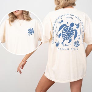 a woman wearing a white shirt with a turtle on it