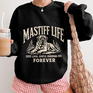 Black sweatshirt with "Mastiff Life Loyal Gentle Guardian Forever" text and dog graphic.