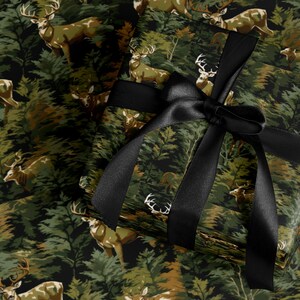a gift box with a black ribbon tied around it, set against a background of a forest with deer.