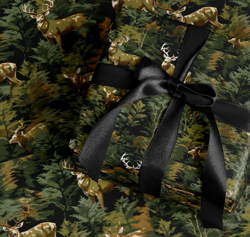 a gift box with a black ribbon tied around it, set against a background of a forest with deer.