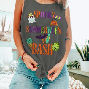 May include: Dark grey vest top with the words "Spooky Summerween Bash" in orange, purple, and green. The design includes a ghost, pumpkin, bat, surfboard, ice cream cone, and tropical leaf. A fun, festive top for Halloween.