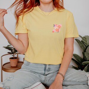 a woman with red hair sitting on a bed