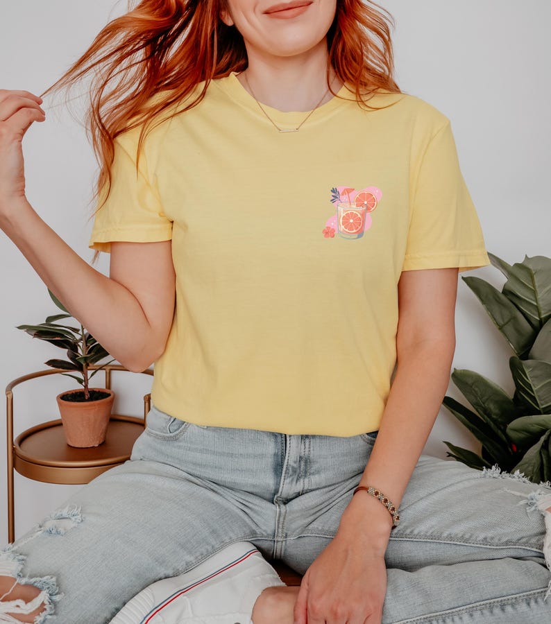 a woman with red hair sitting on a bed