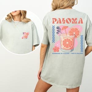 a woman is wearing a shirt with a picture of a drink on it