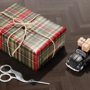 A gift box wrapped in a plaid paper with a bow, a pair of scissors, and a small toy car on a wooden floor.