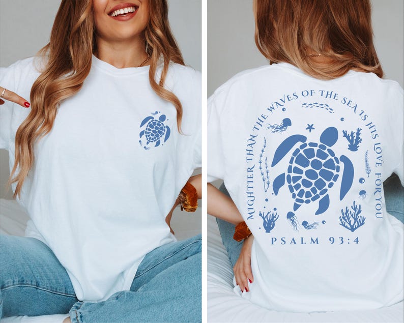 a woman sitting on a bed wearing a t - shirt with a turtle on it