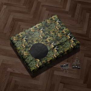 A large, square-shaped object with a black circular cutout in the center, placed on a wooden floor.