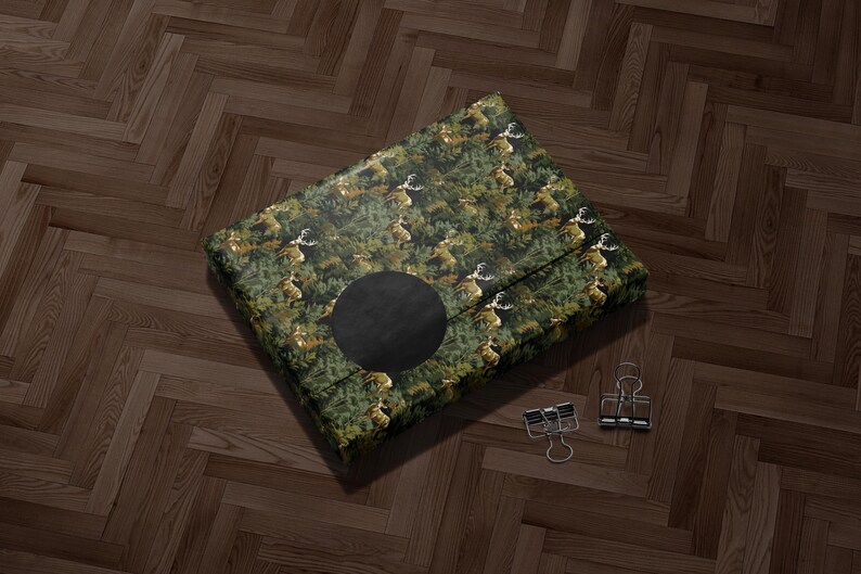 A large, square-shaped object with a black circular cutout in the center, placed on a wooden floor.