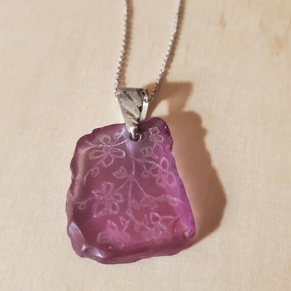 Pendant out of 925 silver with engraved sea glass, is hand made.  It comes with a 925 Sterling Silver 45cm chain. Great and unique gift.
