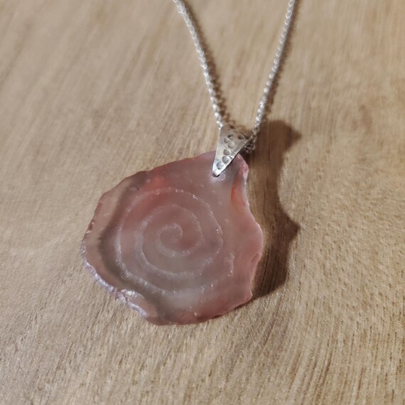 Pendant out of 925 silver with engraved sea glass, is hand made.  It comes with a 925 Sterling Silver 45cm chain. Great and unique gift.
