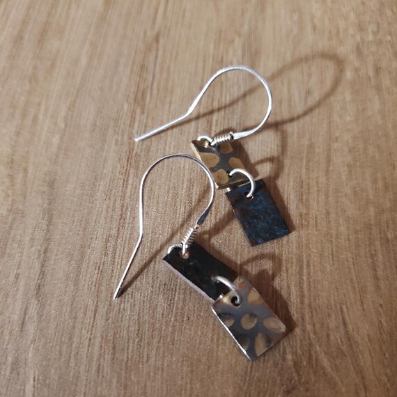 Earrings out 925 silver and of patinated and textured  copper and casting metal, are crafted to reflect my style of work.  Great gift !
