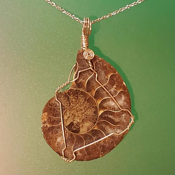 Pendant out of 925 silver is set with a Ammonite fossil, and is all hand made.  It comes with a 925 Sterling Silver 45cm chain. Great gift