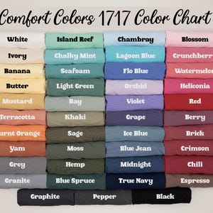 May include: A color chart titled "Comfort Colors 1717 Color Chart" displays a variety of fabric colors. The chart includes shades like white, ivory, banana, butter, mustard, terracotta, burnt orange, yam, grey, and granite.
