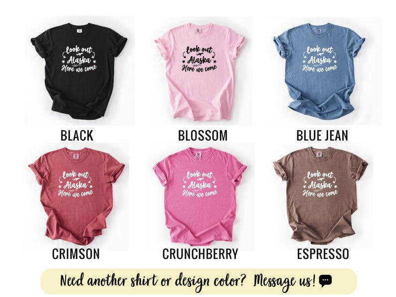 May include: A collection of six t-shirts in various colors: black, blossom, blue jean, crimson, crunchberry, and espresso. Each shirt displays the text "look out Alaska, Here we come" in white script. The bottom of the image has the text "Need another shirt or design color? Message us!"