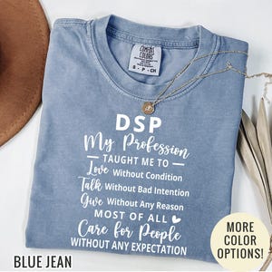 May include: A blue jean colored t-shirt with white text that reads: DSP My Profession TAUGHT ME TO Love Without Condition Talk Without Bad Intention Give Without Any Reason MOST OF ALL Care for People WITHOUT ANY EXPECTATION. Includes a small heart icon.