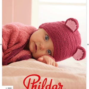 May include: A pink knitted baby hat with bear ears. The hat is made with a soft yarn and has a simple design. The hat is part of a knitting pattern book for baby clothes.