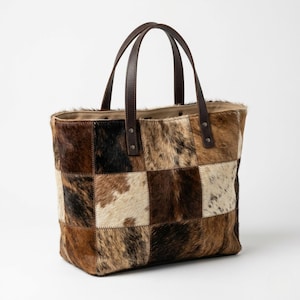 May include: A set of three ceramic mugs with a speckled, matte finish. The mugs are in shades of cream, light gray, and dark gray. Each mug has a simple, minimalist design and a rounded handle.