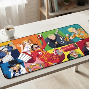May include: A rectangular desk mat featuring a colorful collage of various anime characters from One Piece, including Luffy in a red outfit, Zoro, Sanji, Nami, and others, set against vibrant orange, green, yellow, and blue background panels.