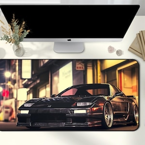 May include: Black car mousepad featuring a detailed illustration of a sports car on a city street at night. The mousepad has a rectangular shape and is designed to fit under a computer mouse. The background shows a blurred street scene.