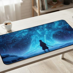 May include: A rectangular mouse pad featuring a blue and white fantasy landscape with a silhouetted figure holding a sword. The design includes a swirling, ethereal tree-like structure and a starry sky.
