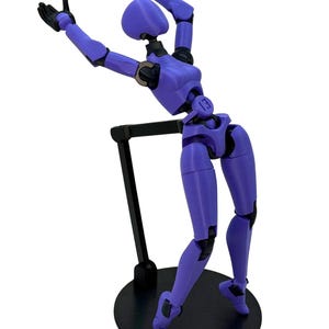 A purple 3D-printed articulated action figure arching backward while supported by a black stand on a circular base.