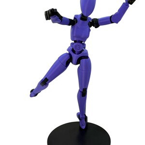 A purple 3D-printed articulated action figure posed dynamically on a black circular stand.