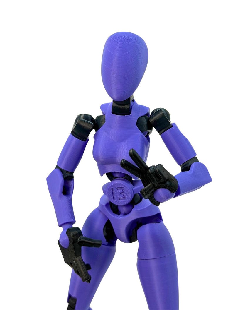 Close-up of a purple 3D-printed articulated action figure with black joints, making a peace sign with one hand.