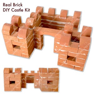 May include: A DIY castle kit made of small, real bricks. The kit includes multiple sections of a castle, including towers and a gate. The bricks are reddish-brown with white mortar, and the text "Real Brick DIY Castle Kit" is visible.