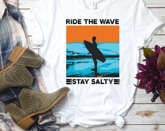 Ride The Wave Stay Salty Surf T-Shirt, Vintage Surfing Quote Tee, Salty Ocean Vibes Shirt, Coastal Beachwear Graphic Tee for Surfers Tees