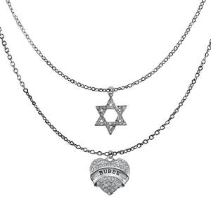 May include: A silver necklace with two strands. The top strand features a Star of David pendant, and the bottom strand has a heart-shaped pendant with the word "BUBBE" on it. Both pendants and chains are adorned with small, sparkling stones.