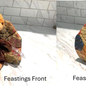 May include: A plush turkey toy with a brown body, tan feet, and a red wattle. The turkey's wings are made of patchwork fabric in shades of brown, red, and gold. The text "Feastings Front" and "Feastings Back" are visible.