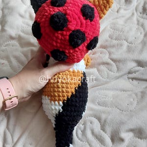 Calico cat crochet plush with ladybug hat