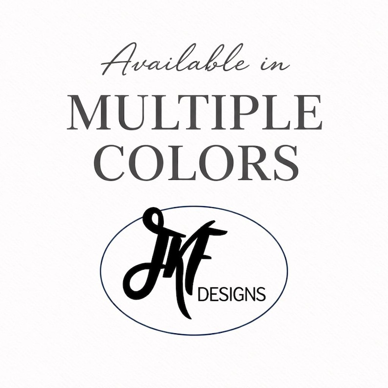 May include: White background with the text "Available in MULTIPLE COLORS" in a dark gray script font. Below the text is a black oval with the letters "JMF" in a stylized script and the word "DESIGNS" in a sans-serif font.