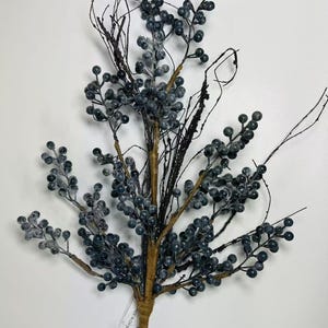 May include: A frosted blue berry spray with brown stems and black wire accents. The spray is approximately 18 inches long.