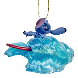 May include: A blue Stitch figurine surfing on a translucent blue wave with a red surfboard. The ornament has a gold string for hanging. The figurine is a popular character from the Disney movie Lilo & Stitch.