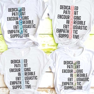 May include: Four white t-shirts with the word "TEACHER" spelled out vertically using words like "Dedicated", "Patient", and "Encouraging". The letters in the word "TEACHER" are highlighted in different colors. The shirts are knotted at the bottom.