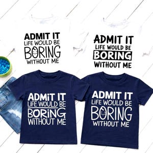 May include: Four t-shirts, two white and two navy blue, with the text "ADMIT IT LIFE WOULD BE BORING WITHOUT ME" in black and white. The shirts are short-sleeved and appear to be made of cotton.