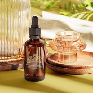 May include: A brown glass bottle with a dropper top and a gold label that reads "Majestic Beauty Products Grow, Thrive, Glow". The bottle is sitting on a wooden surface.