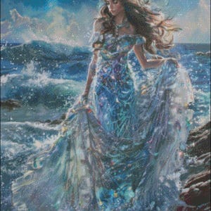 May include: A woman in a flowing blue dress stands in the ocean waves. The dress is adorned with sparkling details and her hair is flowing in the wind. The water is a vibrant blue and the sky is a soft blue with white clouds.